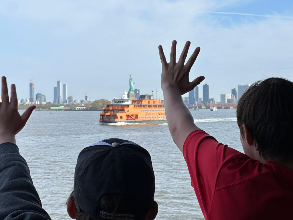 Scouts wave at a passing ferry. 